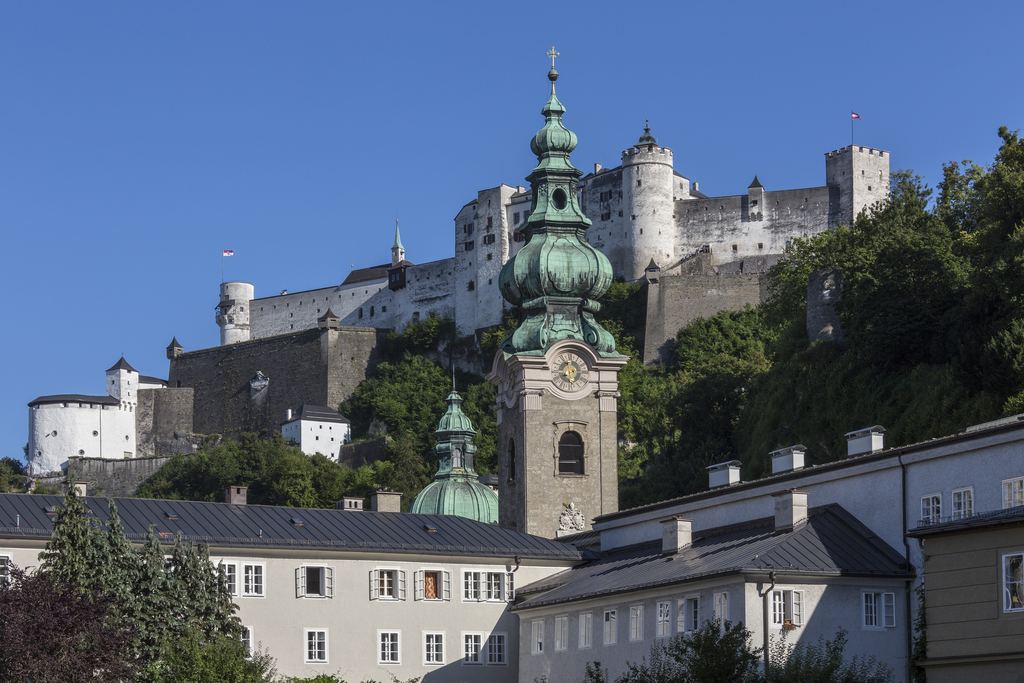 The Hohensalzburg fortress on its wooded ridge above the domes and roofs of the old town of Salzburg.