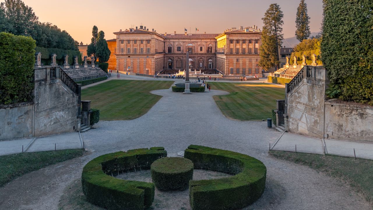 The long front of Palazzo Pitti seen across the box parterre of the Boboli Gardens in the last light of the day.