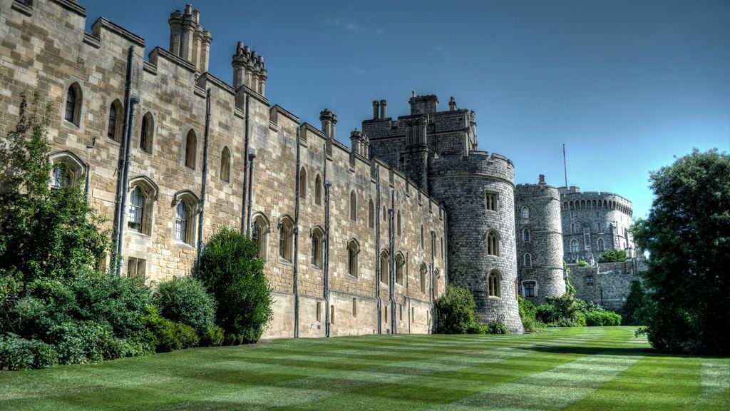 The battlemented range around Saint George Chapel at Windsor Castle, seen from the lawn below the walls.