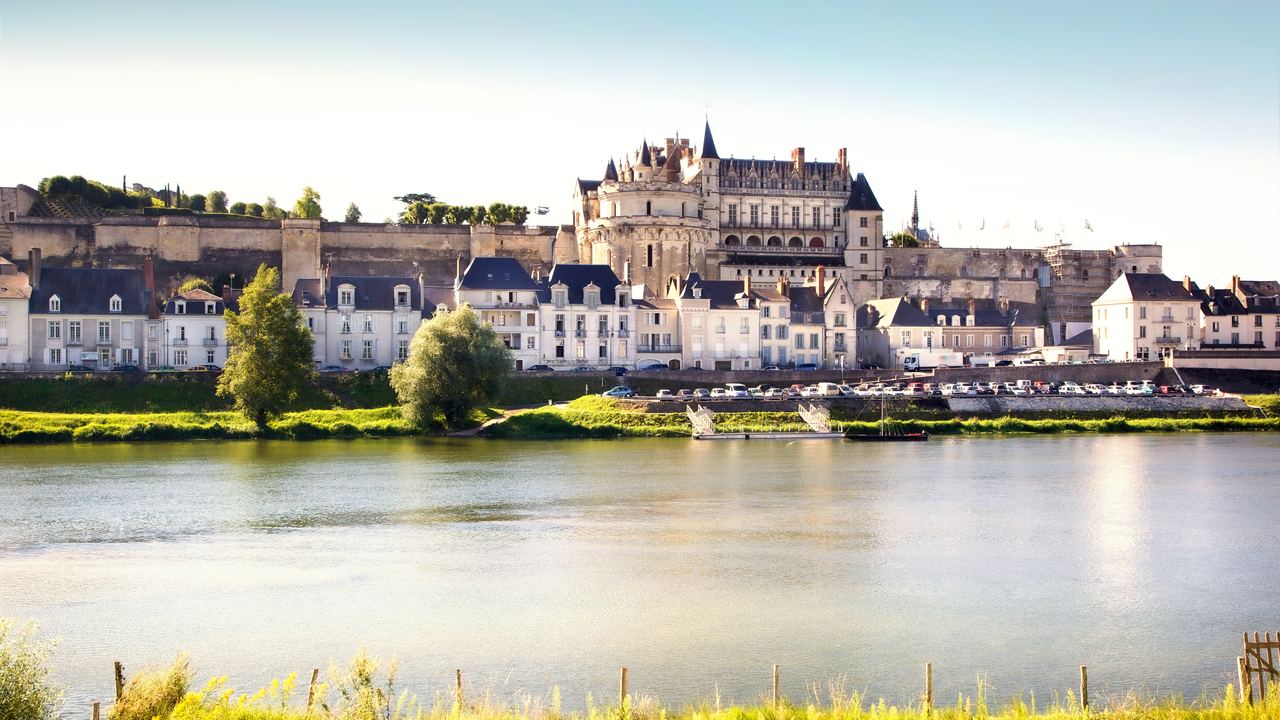 The chateau of Amboise standing above the roofs of the town on the far bank of the river Loire.