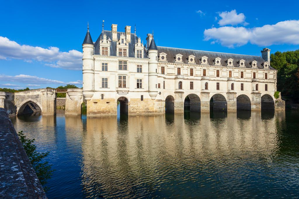 The arches of the Chenonceau gallery and their reflection in the dark water of the Cher.