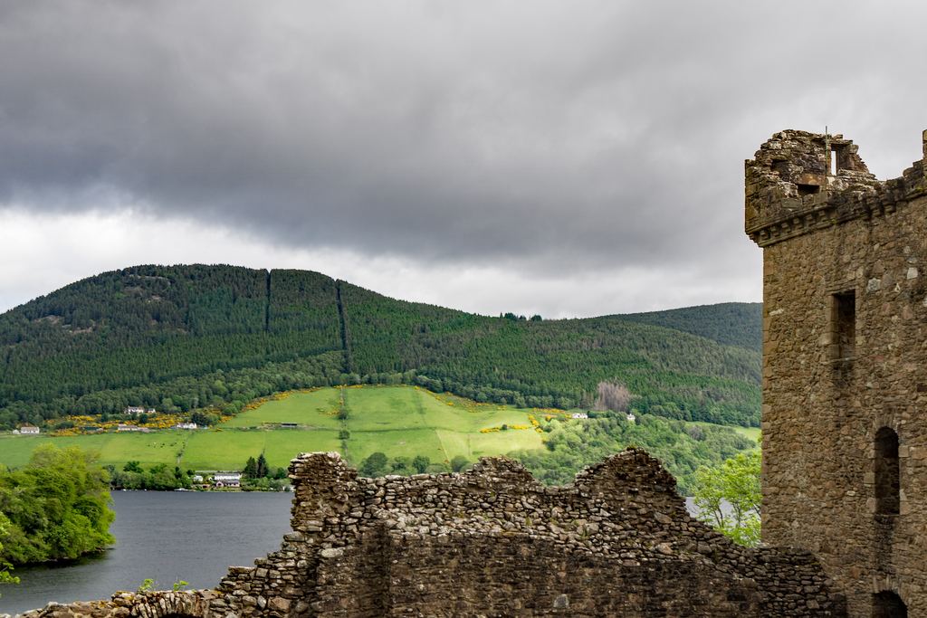 The surviving Grant Tower of Urquhart Castle standing above the shore of Loch Ness.