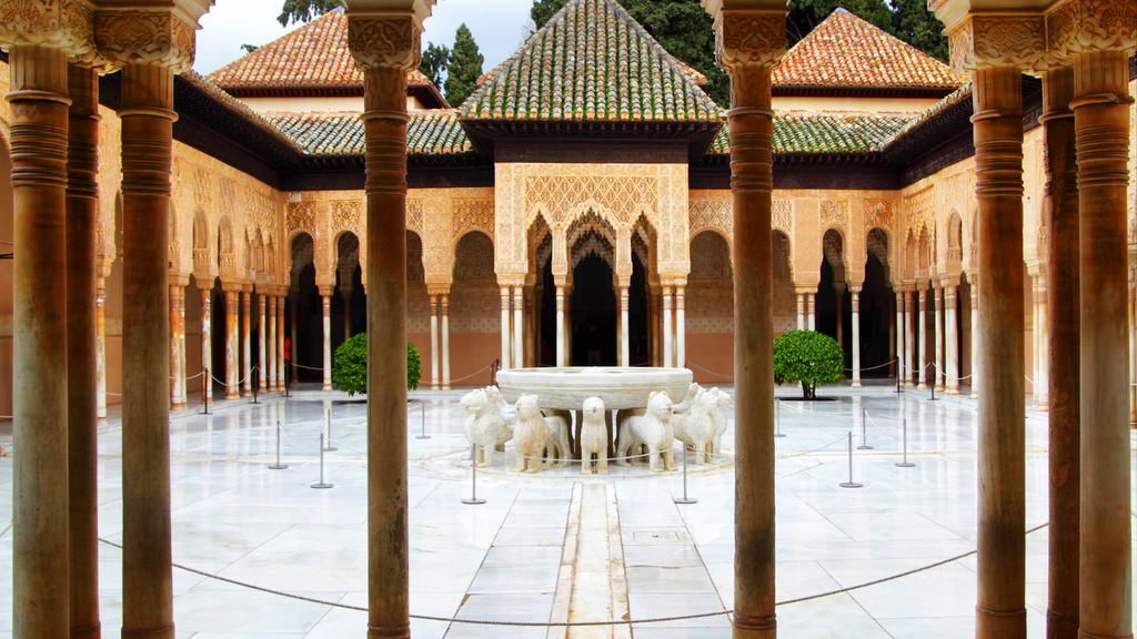Slender marble columns framing the lion fountain at the centre of the Court of the Lions in the Alhambra.