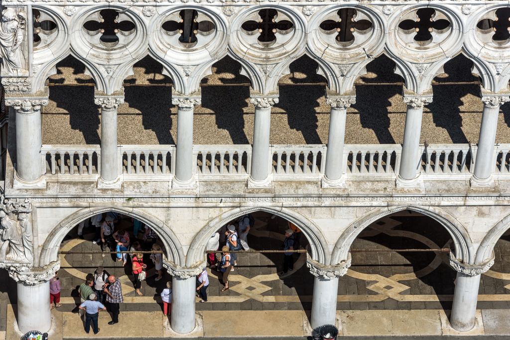 The carved stone tracery and arcade of the Doge's Palace in Venice, seen close from the piazzetta below.