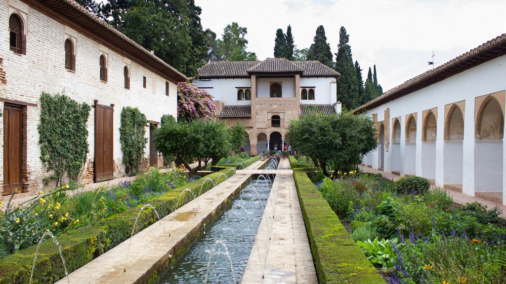 The long water channel and crossed jets of the Patio de la Acequia in the Generalife gardens at Granada.