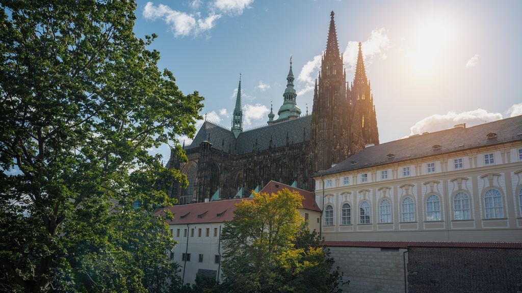 The gothic spires and flying buttresses of St Vitus Cathedral rising inside the courtyards of Prague Castle.