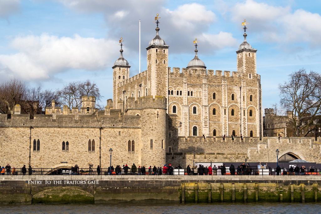 The White Tower and the riverside wall of the Tower of London seen from the bank of the Thames.